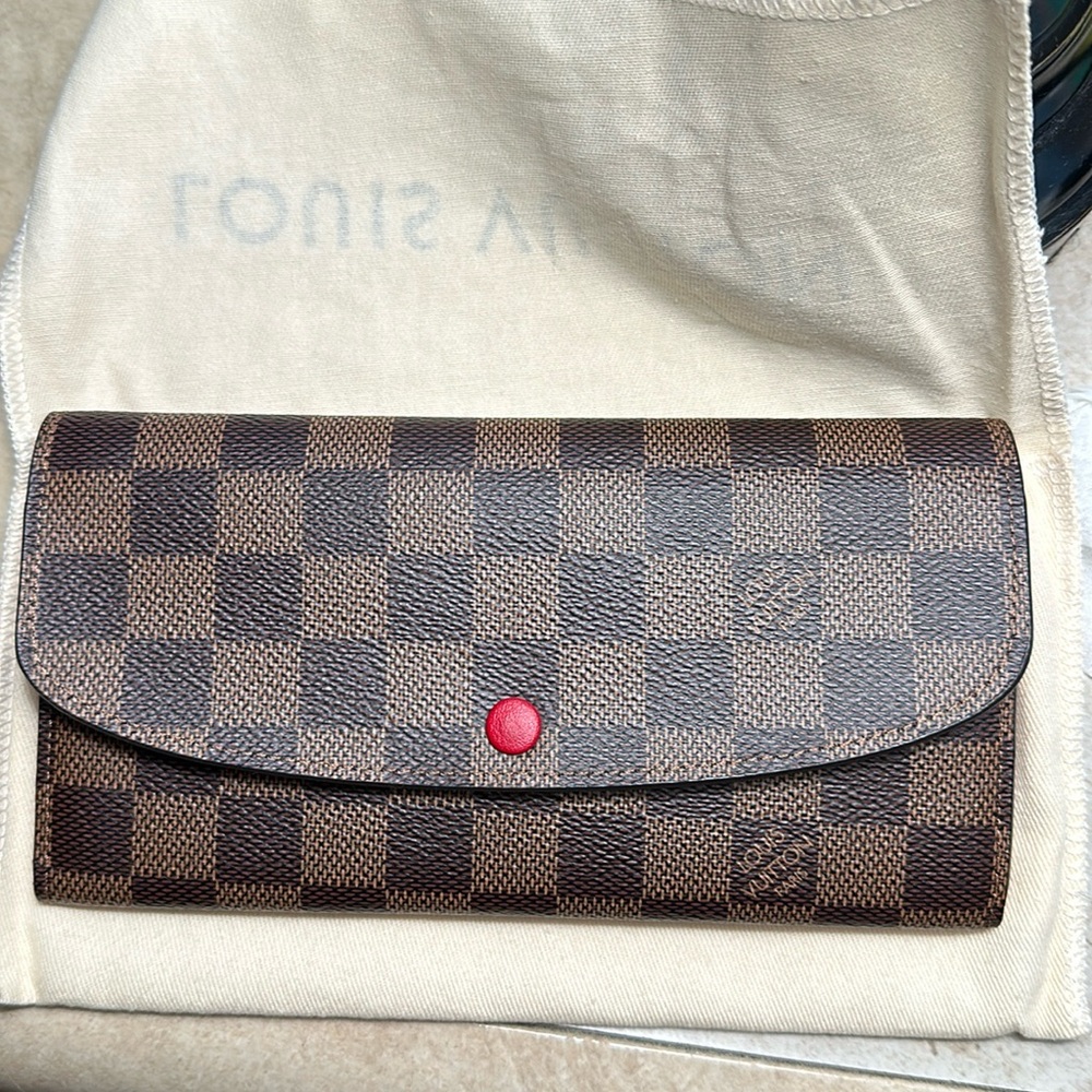 Louis Vuitton Emelie wallet in Damier Ebene print with red interior